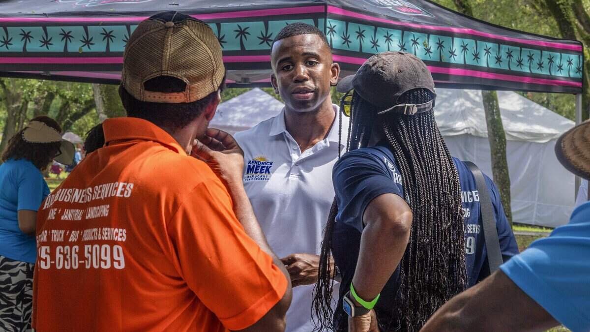 Kendrick Meek Jr. talks with attendees at the South Florida HBCU Picnic in Rolling Oaks Park, Miami Gardens.